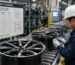 A production line of custom alloy wheels being inspected for quality compliance