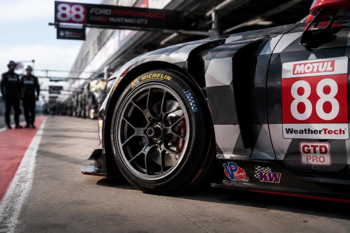 High-performance track-specific custom forged wheels mounted on a race car in pit lane